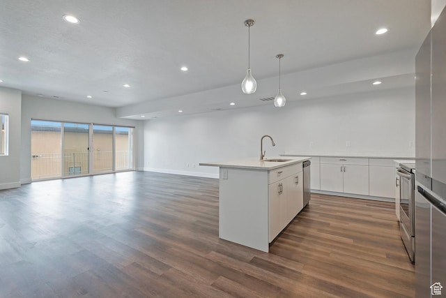 kitchen featuring a center island with sink, light countertops, appliances with stainless steel finishes, white cabinetry, and a sink