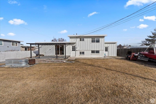6357 W 3570 S, West Valley City, UT 84128 - rear view of house featuring fence, a lawn, and board and batten siding