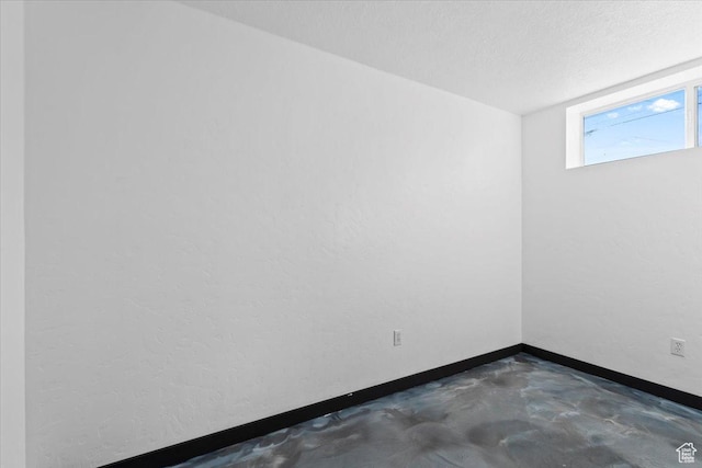 6357 W 3570 S, West Valley City, UT 84128 - empty room with concrete floors, a textured ceiling, and baseboards