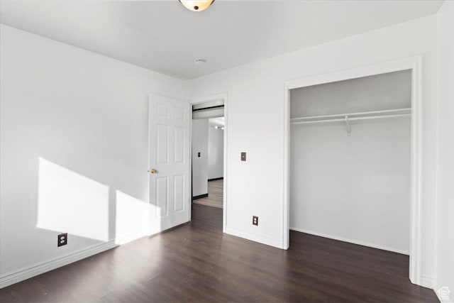 6357 W 3570 S, West Valley City, UT 84128 - unfurnished bedroom with a closet, baseboards, and dark wood-type flooring