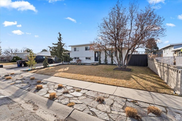 6357 W 3570 S, West Valley City, UT 84128 - split level home featuring a front yard and fence