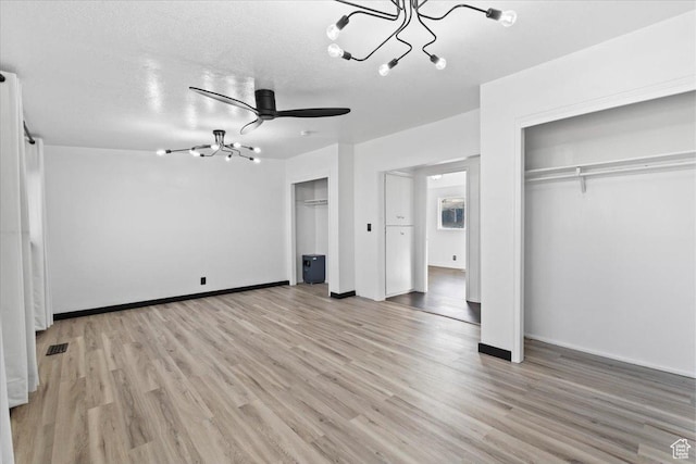 6357 W 3570 S, West Valley City, UT 84128 - unfurnished bedroom with light wood-type flooring, visible vents, a chandelier, and multiple closets