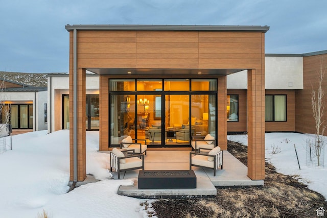 snow covered house with a patio area