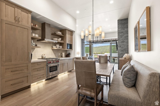 6427 Double Deer Loop, Park City, UT 84098 - kitchen with light wood finished floors, an inviting chandelier, open shelves, premium stove, and open floor plan