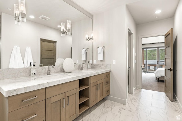 6427 Double Deer Loop, Park City, UT 84098 - ensuite bathroom with double vanity, visible vents, baseboards, and a sink