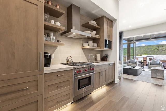 6427 Double Deer Loop, Park City, UT 84098 - kitchen featuring open shelves, backsplash, wood finished floors, wall chimney range hood, and designer range