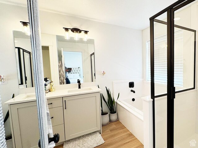 187 W 470 N, Smithfield, UT 84335 - ensuite bathroom with a garden tub, wood finished floors, vanity, a shower stall, and ensuite bath