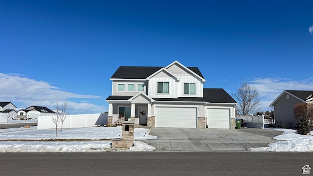 187 W 470 N, Smithfield, UT 84335 - view of front of home featuring an attached garage, board and batten siding, fence, stone siding, and driveway