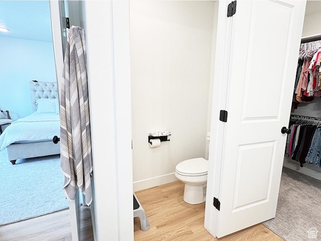 187 W 470 N, Smithfield, UT 84335 - ensuite bathroom with baseboards, connected bathroom, toilet, wood finished floors, and a walk in closet