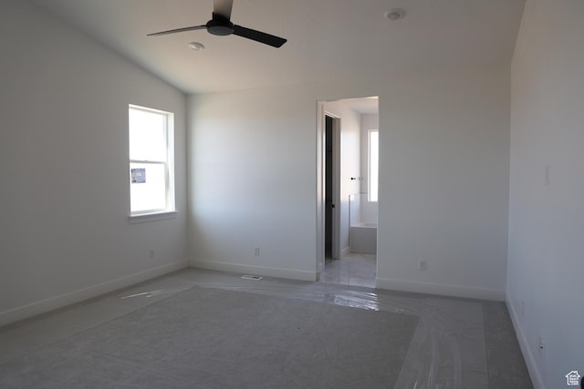 unfurnished room featuring ceiling fan, baseboards, and vaulted ceiling