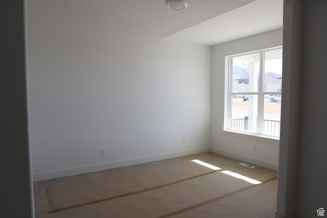 empty room featuring visible vents and baseboards