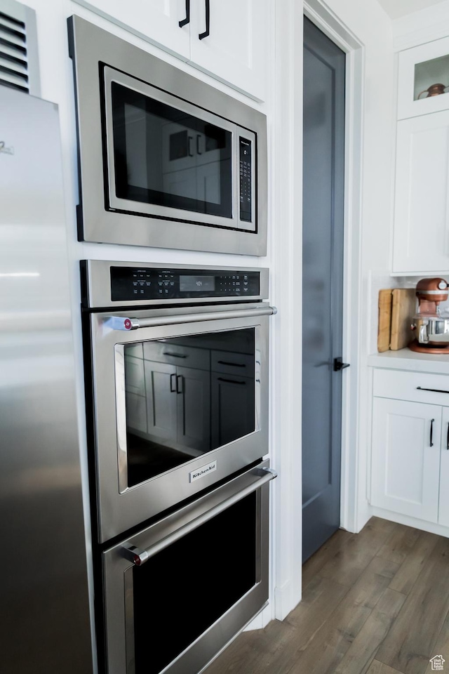 14102 S Sleepy Oaks Ln, Herriman, UT 84096 - kitchen featuring stainless steel appliances, dark wood finished floors, white cabinets, and light countertops