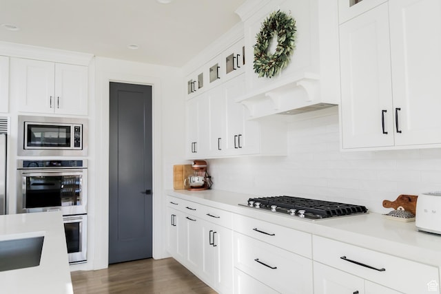 14102 S Sleepy Oaks Ln, Herriman, UT 84096 - kitchen featuring appliances with stainless steel finishes, light countertops, custom range hood, and backsplash