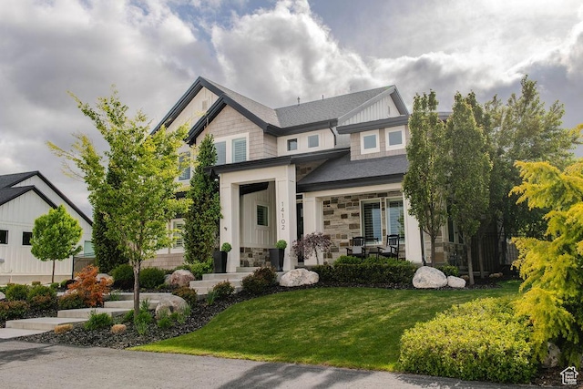 14102 S Sleepy Oaks Ln, Herriman, UT 84096 - craftsman-style home featuring stone siding, a front yard, board and batten siding, and a porch