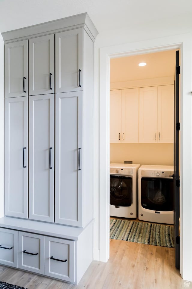 14102 S Sleepy Oaks Ln, Herriman, UT 84096 - laundry area featuring washer and clothes dryer, cabinet space, and light wood-type flooring