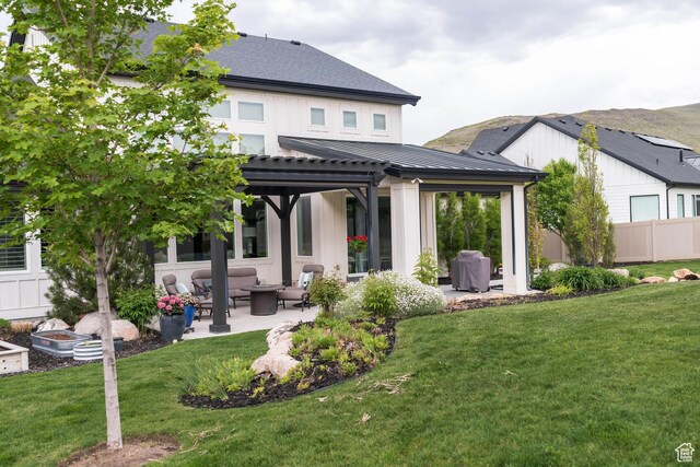 14102 S Sleepy Oaks Ln, Herriman, UT 84096 - back of house with an outdoor hangout area, a patio, a pergola, a standing seam roof, and metal roof
