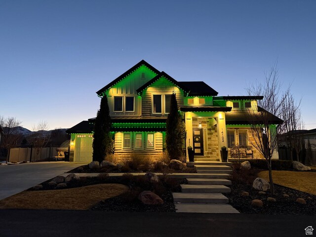 14102 S Sleepy Oaks Ln, Herriman, UT 84096 - view of front of house with concrete driveway, board and batten siding, and covered porch