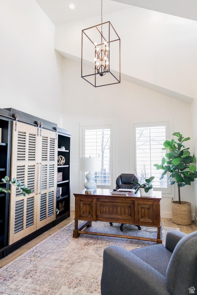 14102 S Sleepy Oaks Ln, Herriman, UT 84096 - office area featuring light wood-type flooring, a chandelier, healthy amount of natural light, high vaulted ceiling, and baseboards