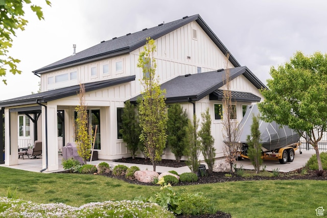 14102 S Sleepy Oaks Ln, Herriman, UT 84096 - back of house with board and batten siding, a patio, and a yard