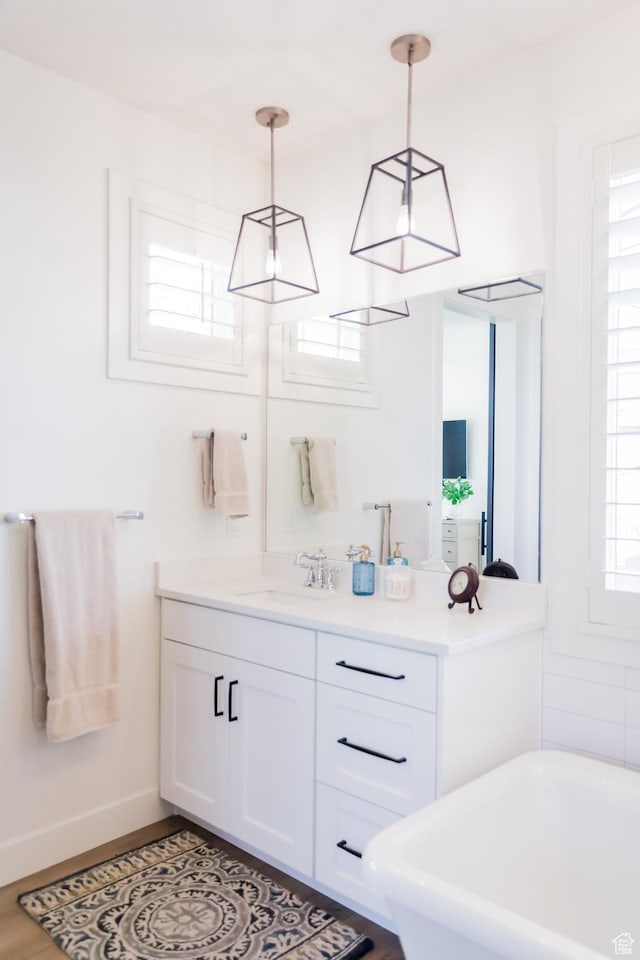 14102 S Sleepy Oaks Ln, Herriman, UT 84096 - full bathroom featuring a freestanding tub, vanity, and baseboards