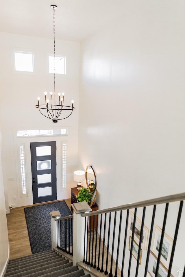 14102 S Sleepy Oaks Ln, Herriman, UT 84096 - entrance foyer featuring wood finished floors, a chandelier, stairs, a high ceiling, and baseboards