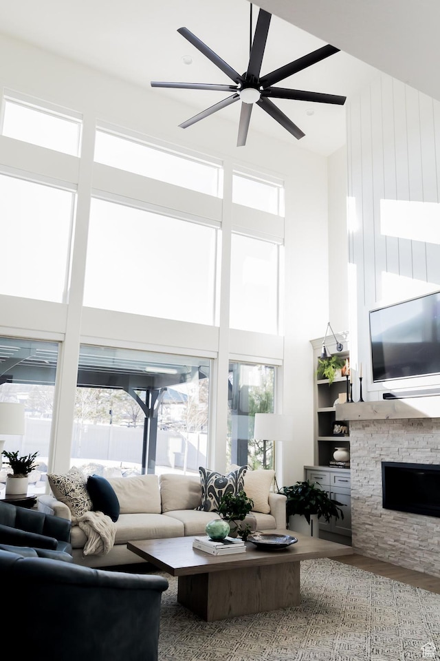 14102 S Sleepy Oaks Ln, Herriman, UT 84096 - living room with plenty of natural light, wood finished floors, a towering ceiling, a fireplace, and ceiling fan