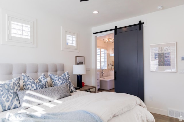 14102 S Sleepy Oaks Ln, Herriman, UT 84096 - bedroom featuring a barn door, wood finished floors, baseboards, recessed lighting, and ensuite bathroom