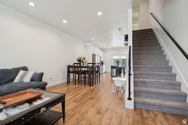 6643 W Skip Rock Rd S, South Jordan, UT 84009 - living room featuring recessed lighting, light wood-style flooring, and stairs