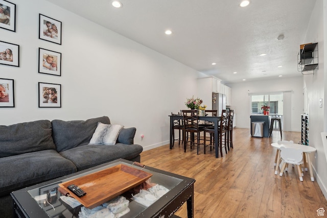 6643 W Skip Rock Rd S, South Jordan, UT 84009 - living area with baseboards, recessed lighting, and light wood-style floors