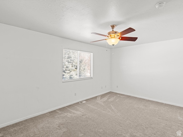262 W 1975 N Unit 40, Ogden, UT 84414 - spare room featuring a textured ceiling, ceiling fan, carpet flooring, visible vents, and baseboards