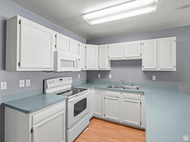 262 W 1975 N Unit 40, Ogden, UT 84414 - kitchen featuring white appliances, white cabinetry, light countertops, and a sink