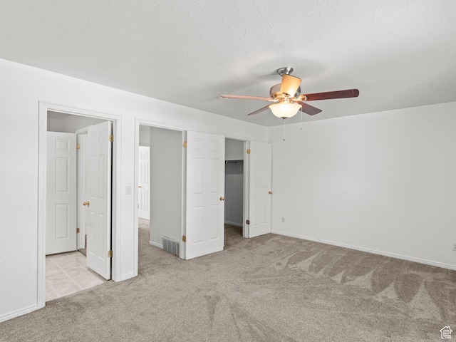 262 W 1975 N Unit 40, Ogden, UT 84414 - unfurnished bedroom with visible vents, light colored carpet, ceiling fan, a spacious closet, and a textured ceiling