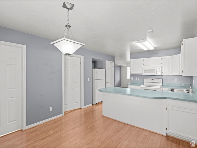 262 W 1975 N Unit 40, Ogden, UT 84414 - kitchen featuring white appliances, white cabinets, light countertops, pendant lighting, and a sink