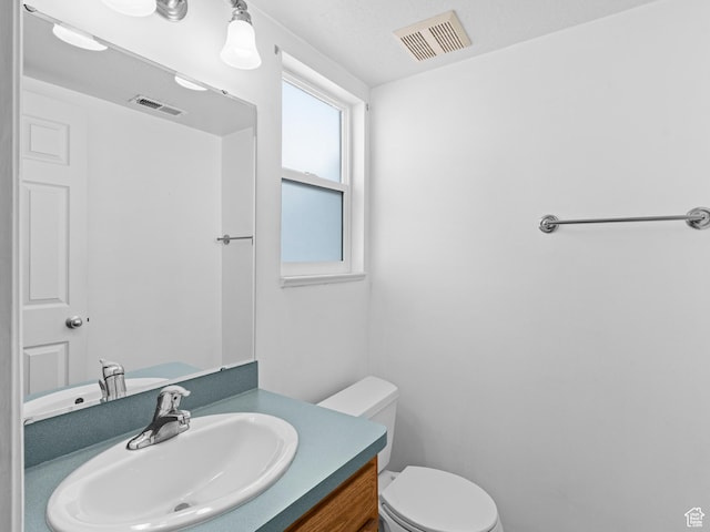 262 W 1975 N Unit 40, Ogden, UT 84414 - bathroom featuring visible vents, vanity, and toilet