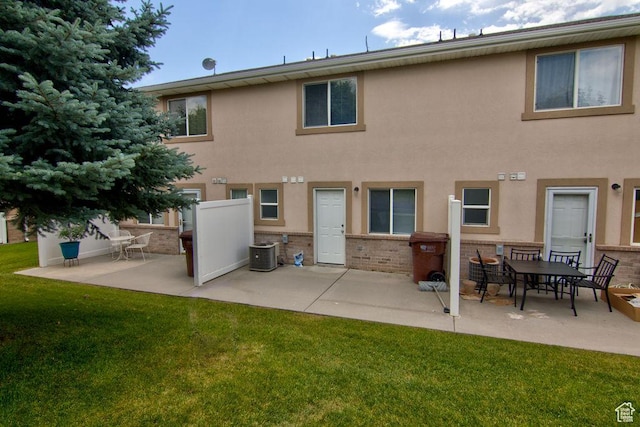 262 W 1975 N Unit 40, Ogden, UT 84414 - rear view of property featuring a patio area, a yard, brick siding, and stucco siding