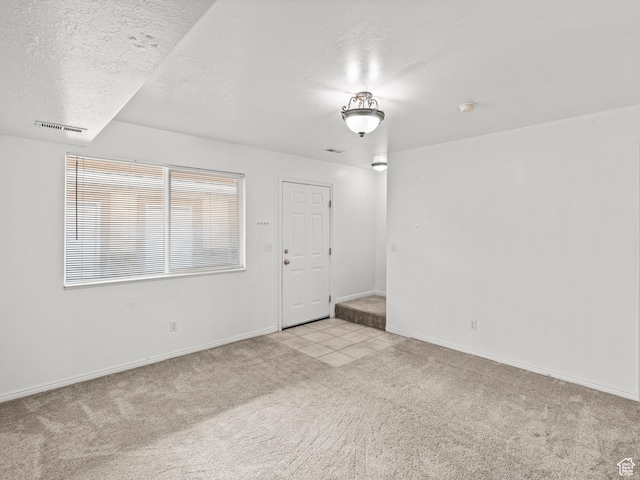 262 W 1975 N Unit 40, Ogden, UT 84414 - unfurnished room featuring visible vents, light colored carpet, a textured ceiling, and baseboards