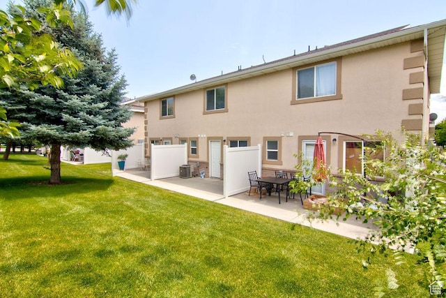 262 W 1975 N Unit 40, Ogden, UT 84414 - rear view of property featuring stucco siding, a patio, and a yard