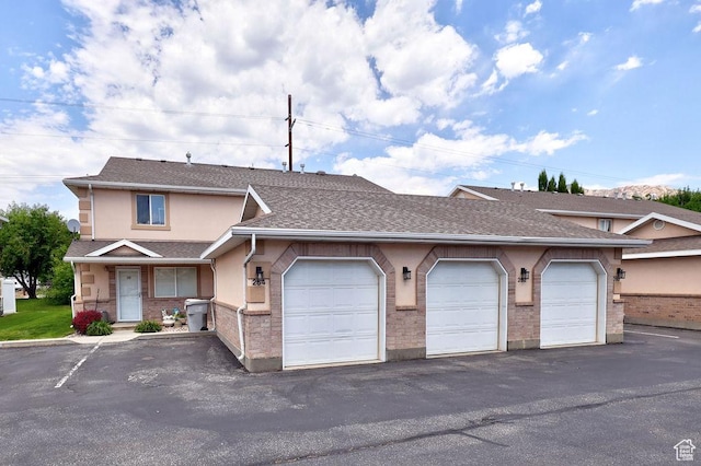 262 W 1975 N Unit 40, Ogden, UT 84414 - townhome / multi-family property with community garages, stucco siding, and roof with shingles