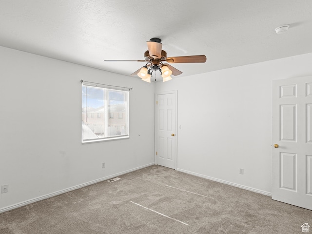262 W 1975 N Unit 40, Ogden, UT 84414 - spare room with light carpet, visible vents, baseboards, and a textured ceiling