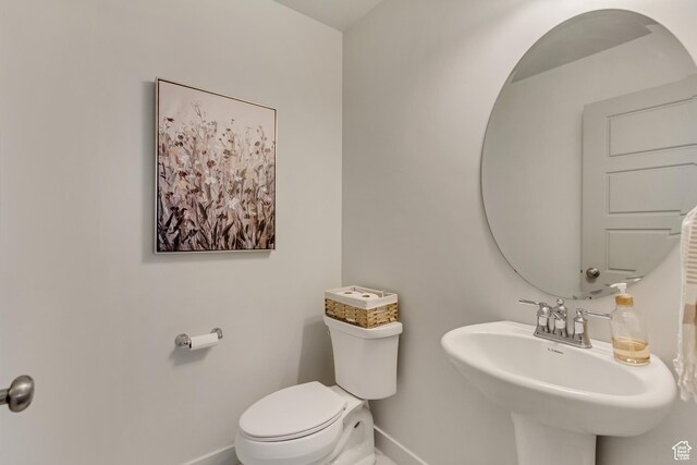 6393 N Pine Tree Way, Eagle Mountain, UT 84005 - bathroom with baseboards, toilet, and a sink