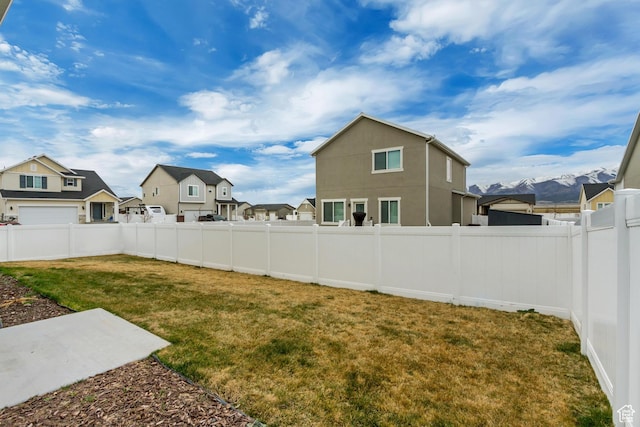 6393 N Pine Tree Way, Eagle Mountain, UT 84005 - view of yard with a fenced backyard and a residential view