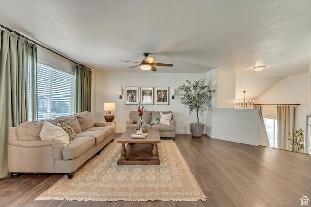 6393 N Pine Tree Way, Eagle Mountain, UT 84005 - living area with baseboards, a textured ceiling, wood finished floors, and a ceiling fan
