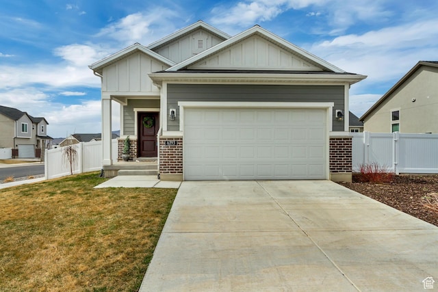 6393 N Pine Tree Way, Eagle Mountain, UT 84005 - craftsman-style home featuring a gate, fence, a garage, concrete driveway, and board and batten siding