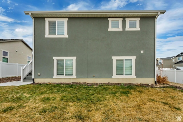 6393 N Pine Tree Way, Eagle Mountain, UT 84005 - back of property featuring stucco siding, fence, and a yard