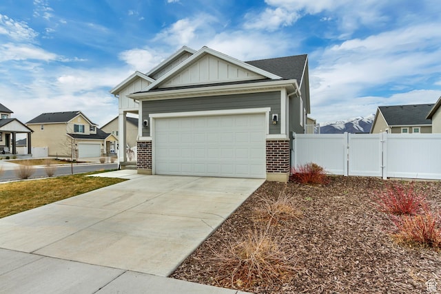 6393 N Pine Tree Way, Eagle Mountain, UT 84005 - view of front of house featuring driveway, a gate, fence, an attached garage, and board and batten siding
