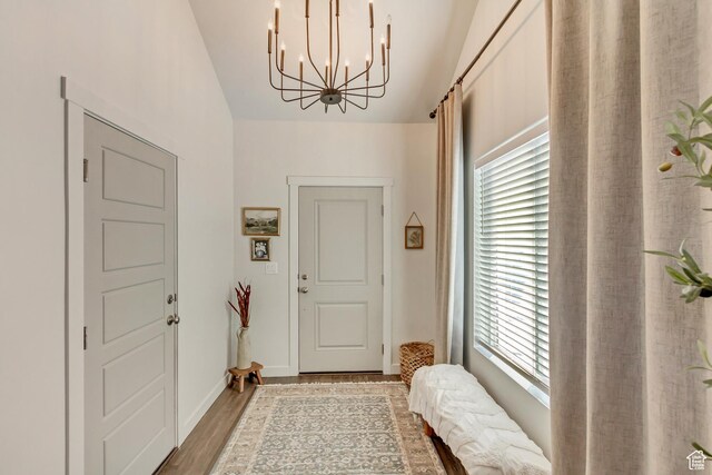6393 N Pine Tree Way, Eagle Mountain, UT 84005 - entrance foyer featuring light wood-style flooring, a notable chandelier, and baseboards