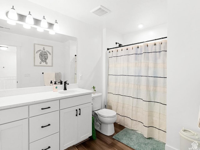 full bath with visible vents, toilet, wood finished floors, curtained shower, and vanity