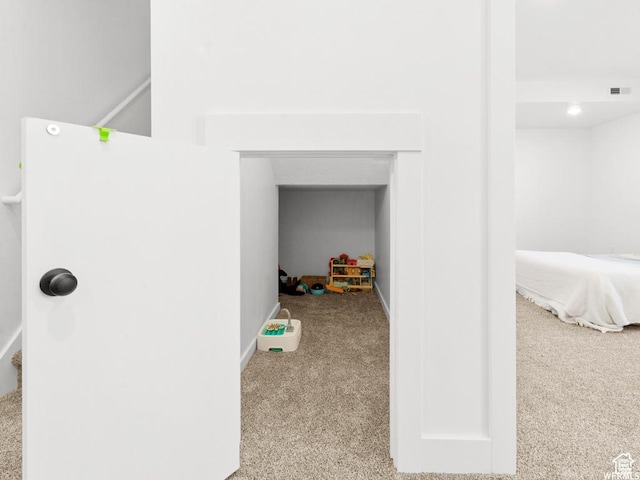 interior space with light carpet, visible vents, and baseboards
