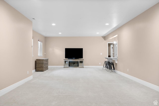 living room with light carpet, baseboards, and recessed lighting
