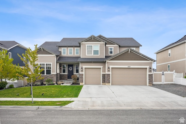 craftsman-style home with concrete driveway, stone siding, and an attached garage